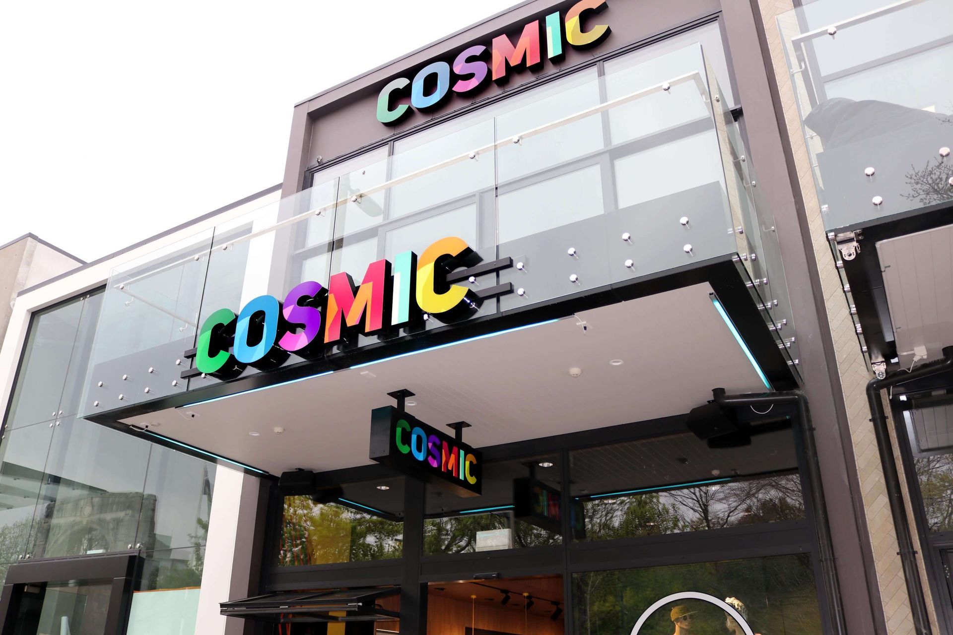 A building with a sign that says cosmic on it Statement Homes Christchurch