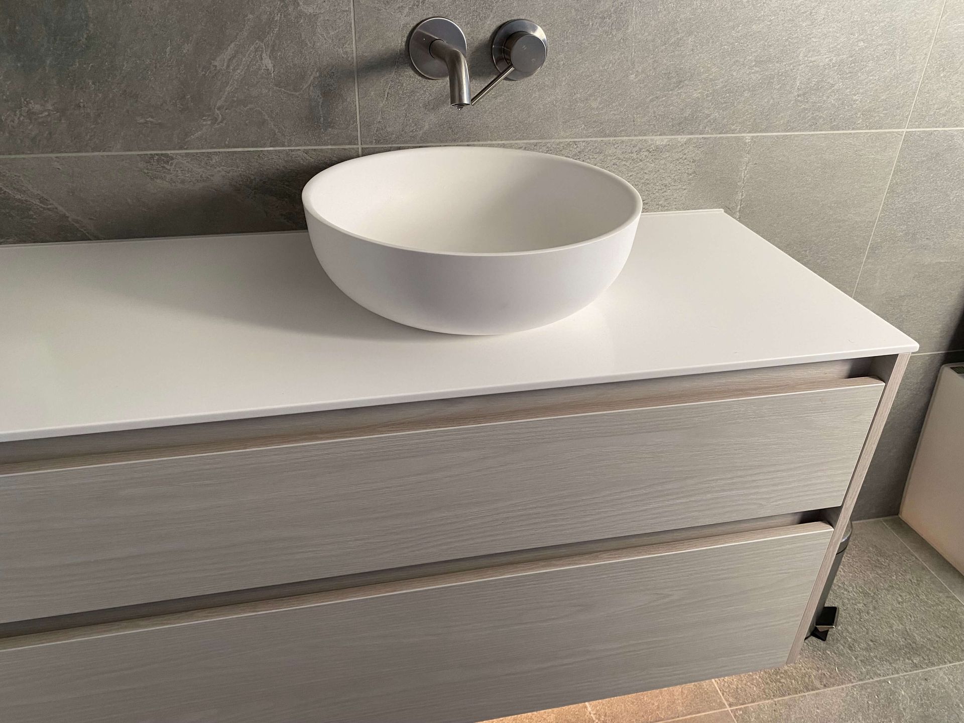 A white sink is sitting on top of a white counter in a bathroom. Statement Homes Christchurch