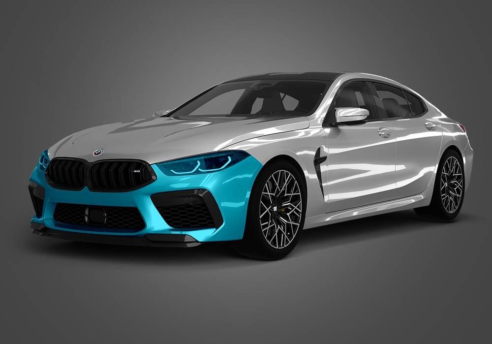 Silver sports coupe with bright blue front bumper on a gray studio background