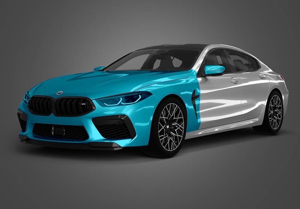 BMW coupe with half teal and half silver body on a gray background