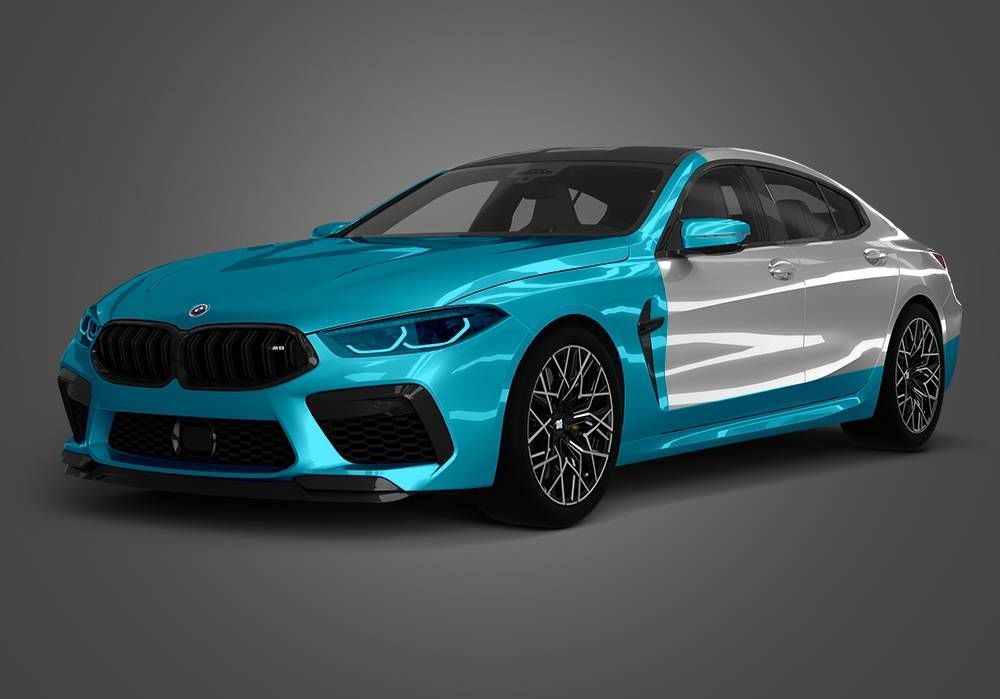Blue and silver BMW sedan on a gray studio background