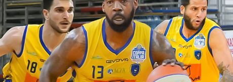Three basketball players in yellow jerseys dribble during a game, with the center player wearing number 13.