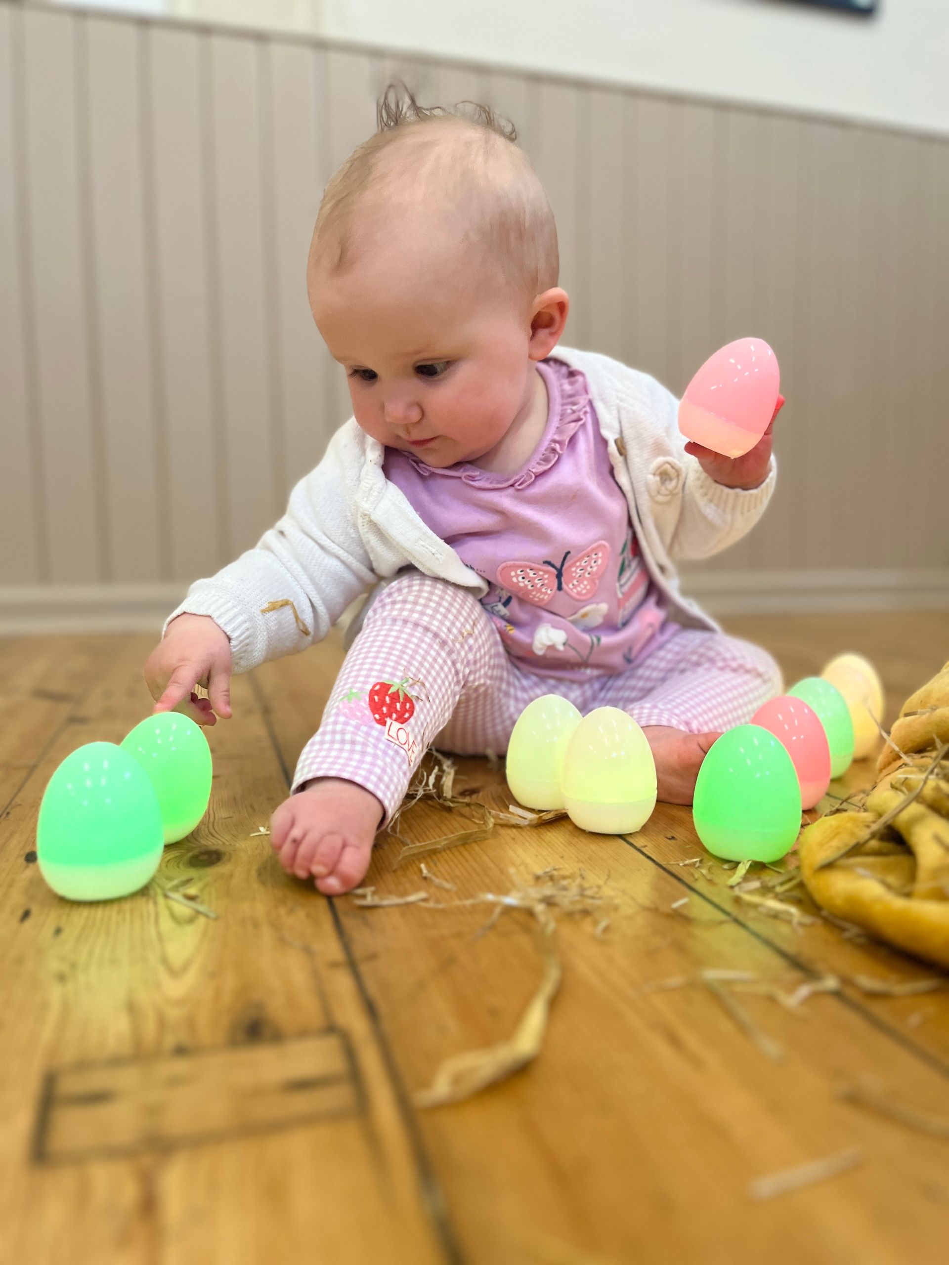 a child playing with light up eggs