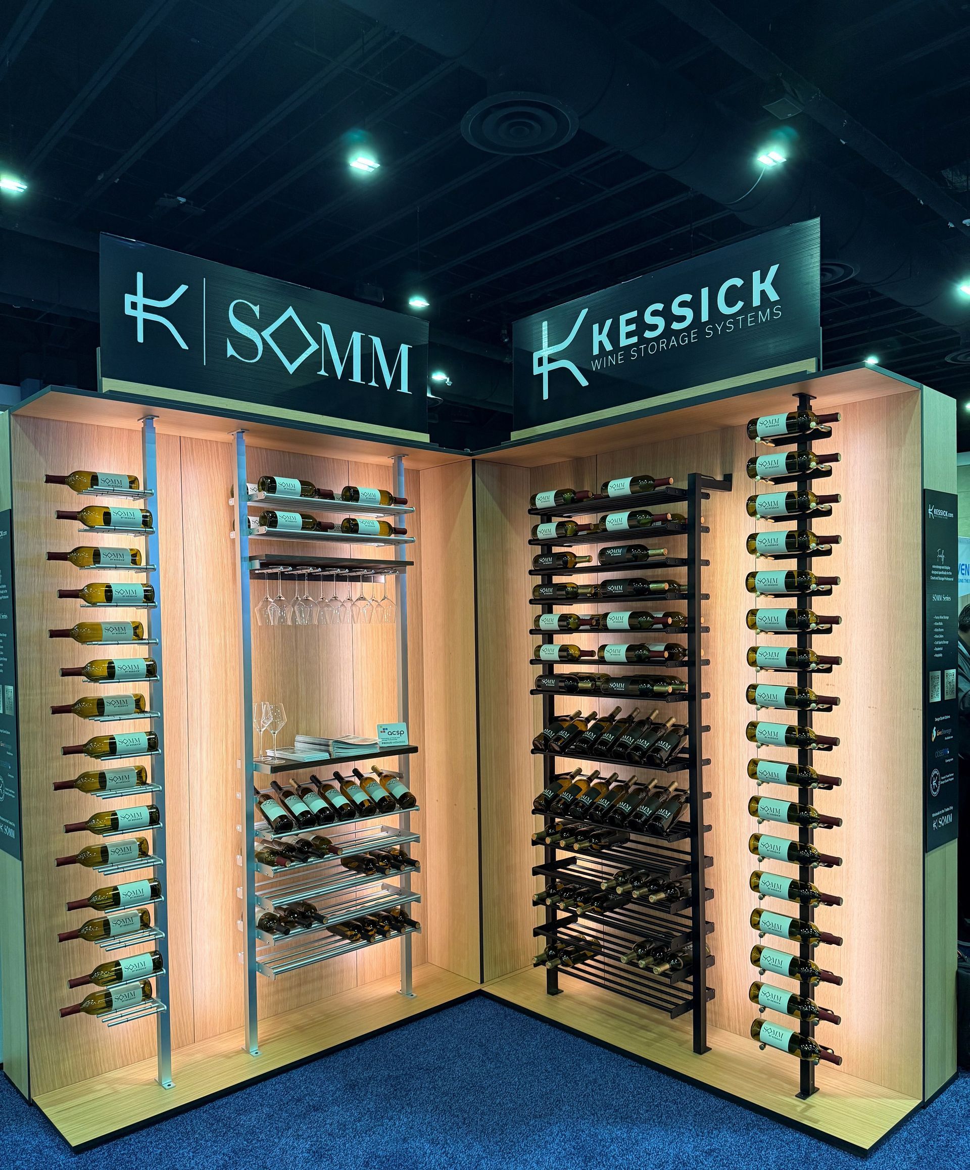 Display booth with illuminated eyeglass frames on wooden wall racks and brand signs overhead.