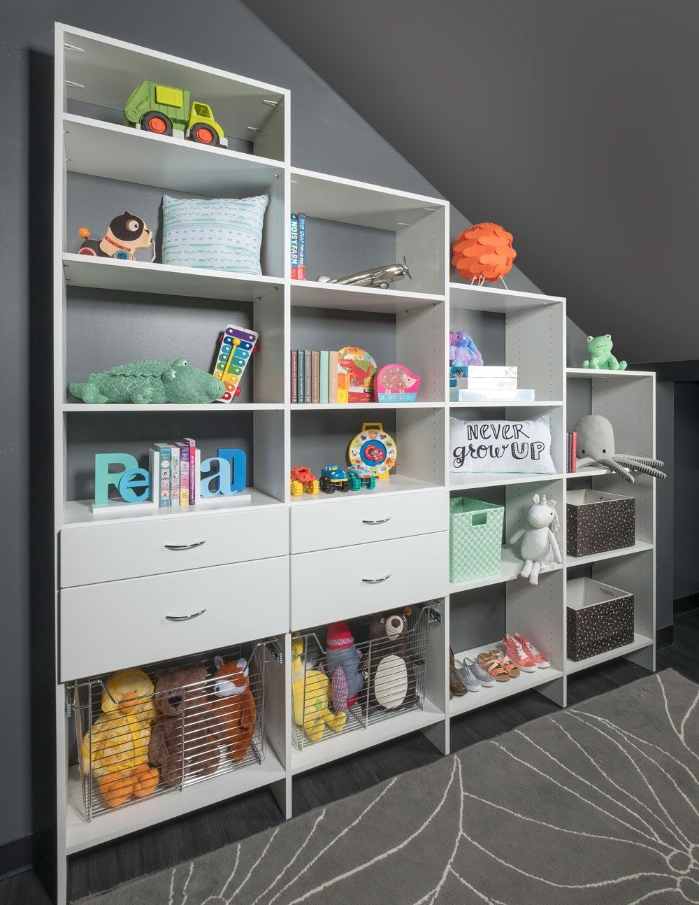 a room with a lot of cubbies and drawers filled with toys .