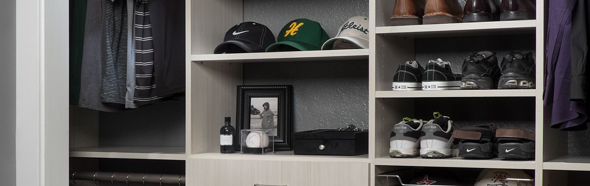 A closet filled with lots of clothes and shoes.