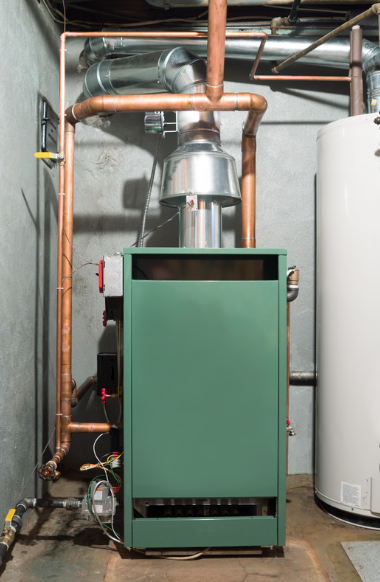 Green boiler/furnace in a utility room with copper pipes and a white water heater