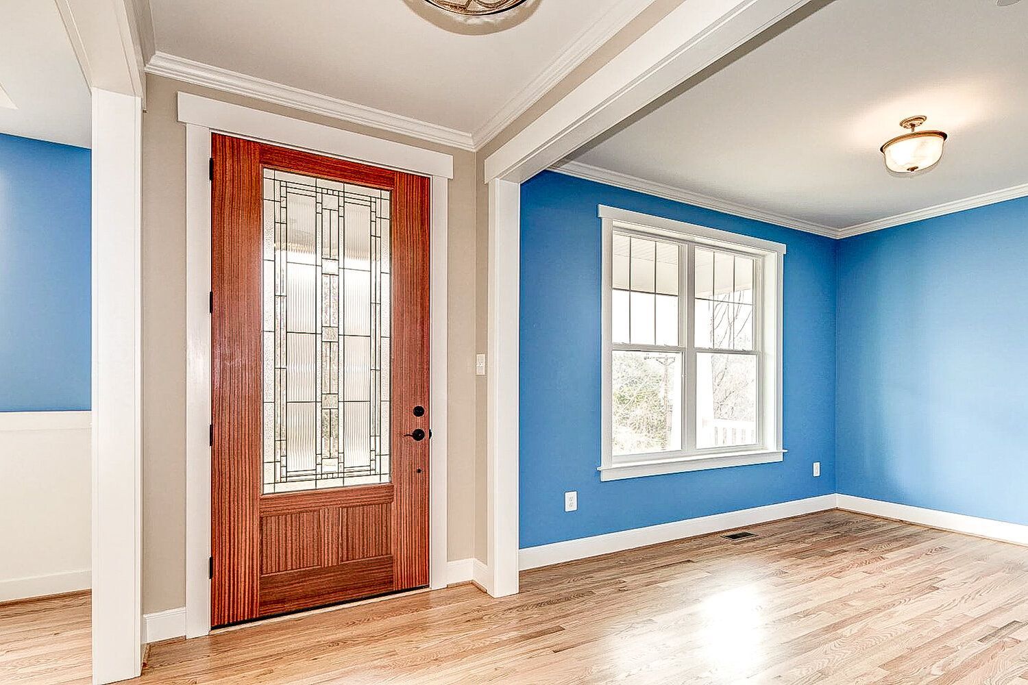 A living room with blue walls and a wooden door.