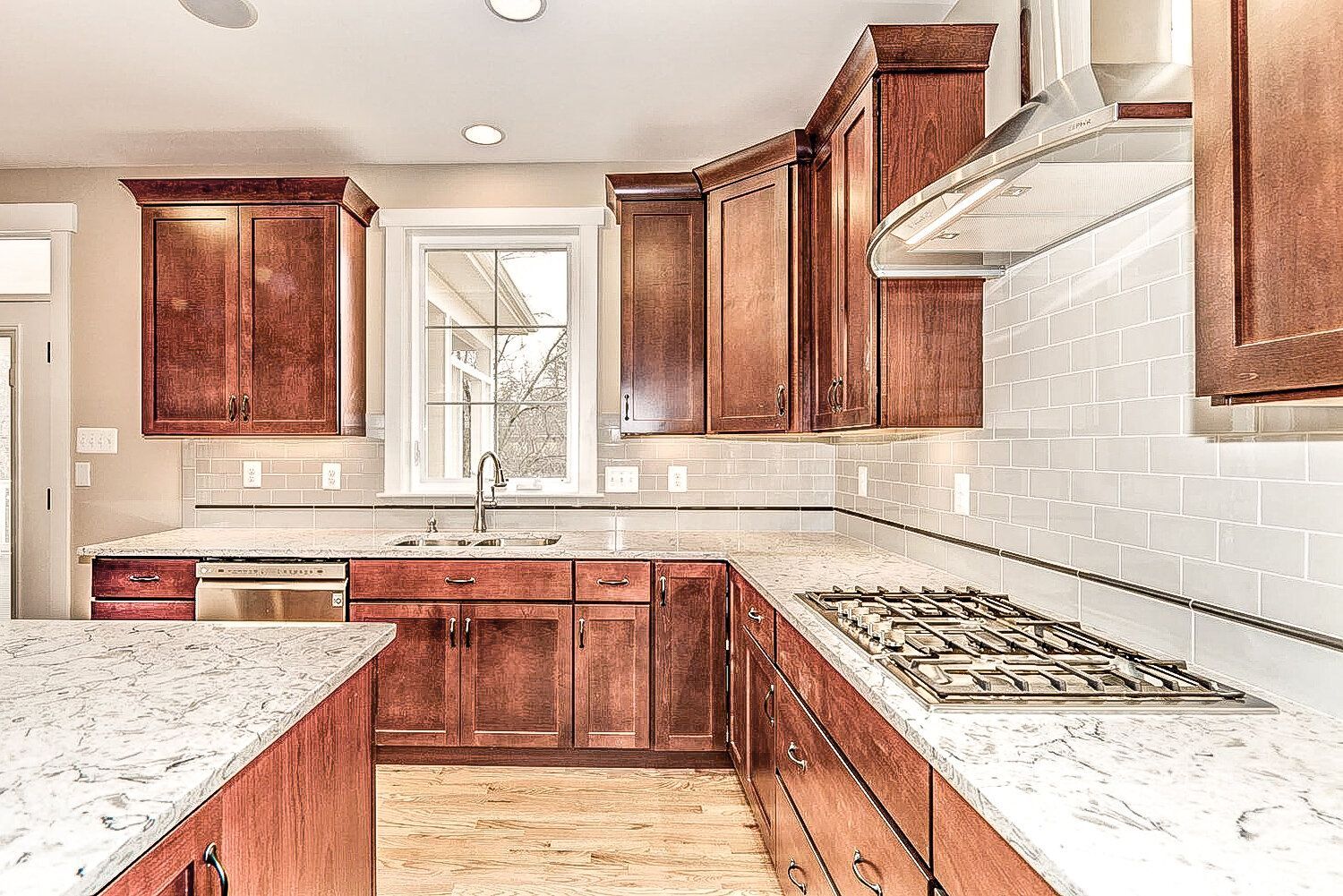 A kitchen with wooden cabinets and granite counter tops.