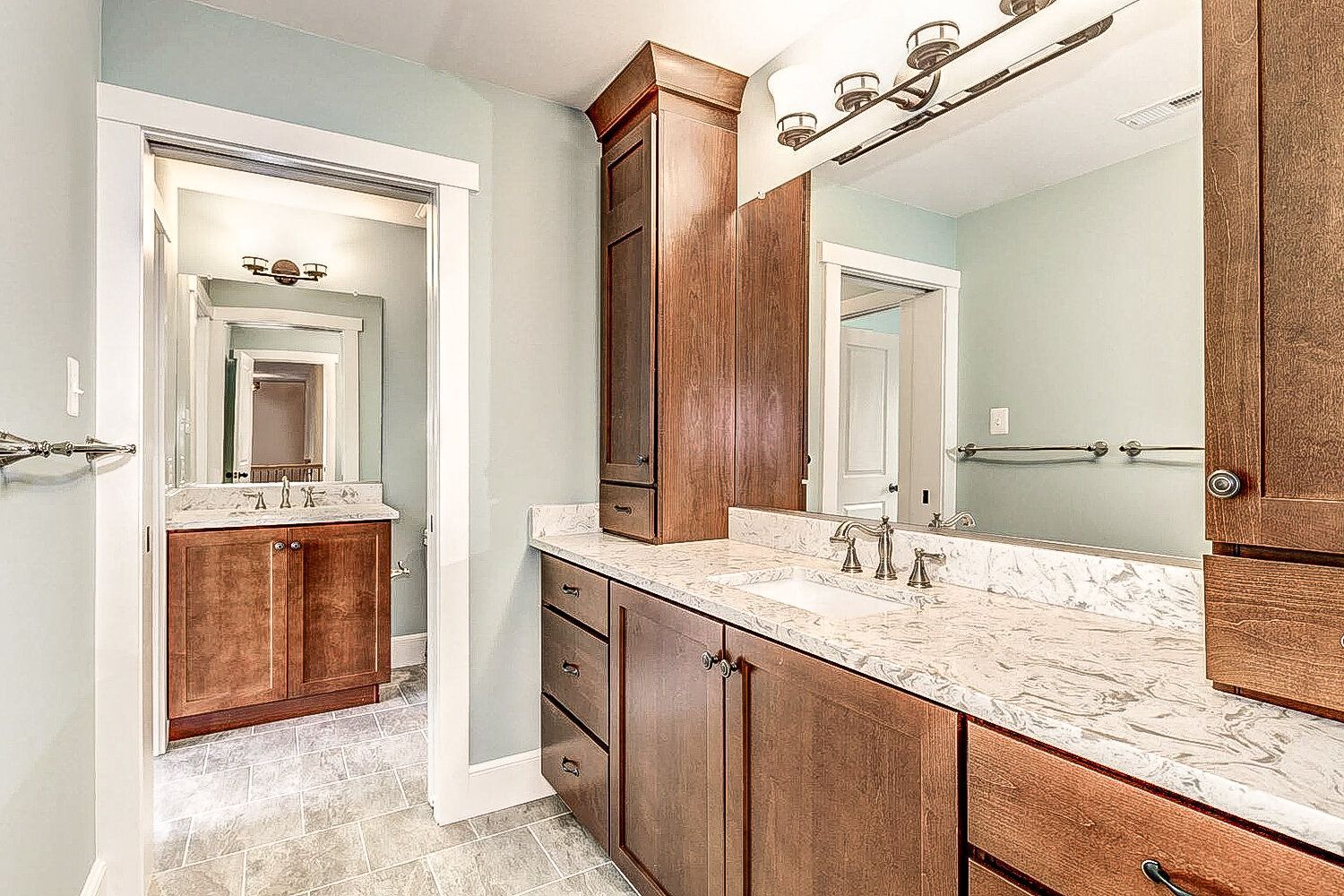 A bathroom with two sinks and a large mirror.
