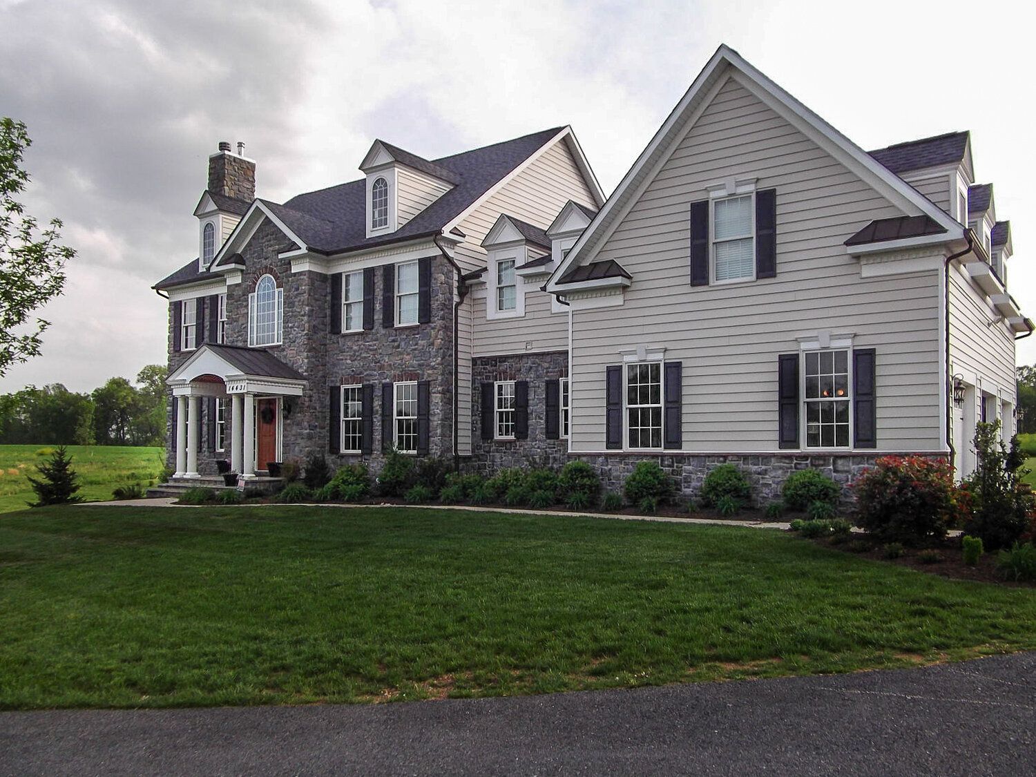 A large house with a lot of windows and shutters