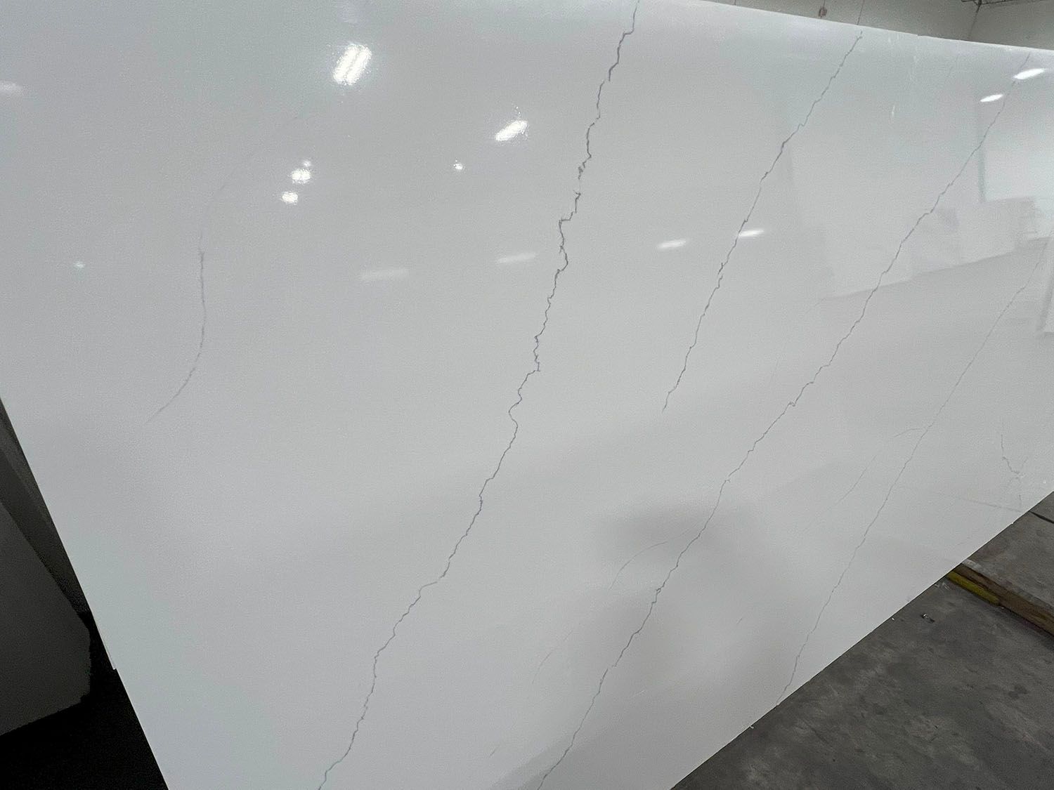 Close-up of a white car door with a long crack in the paint