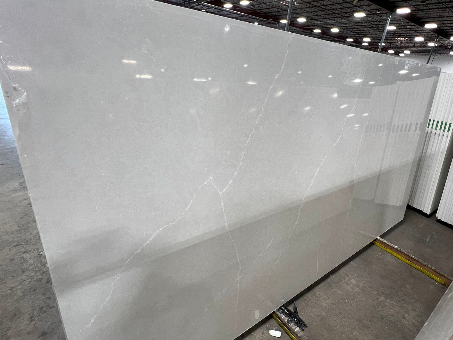 Large white wall panel in an indoor industrial warehouse setting