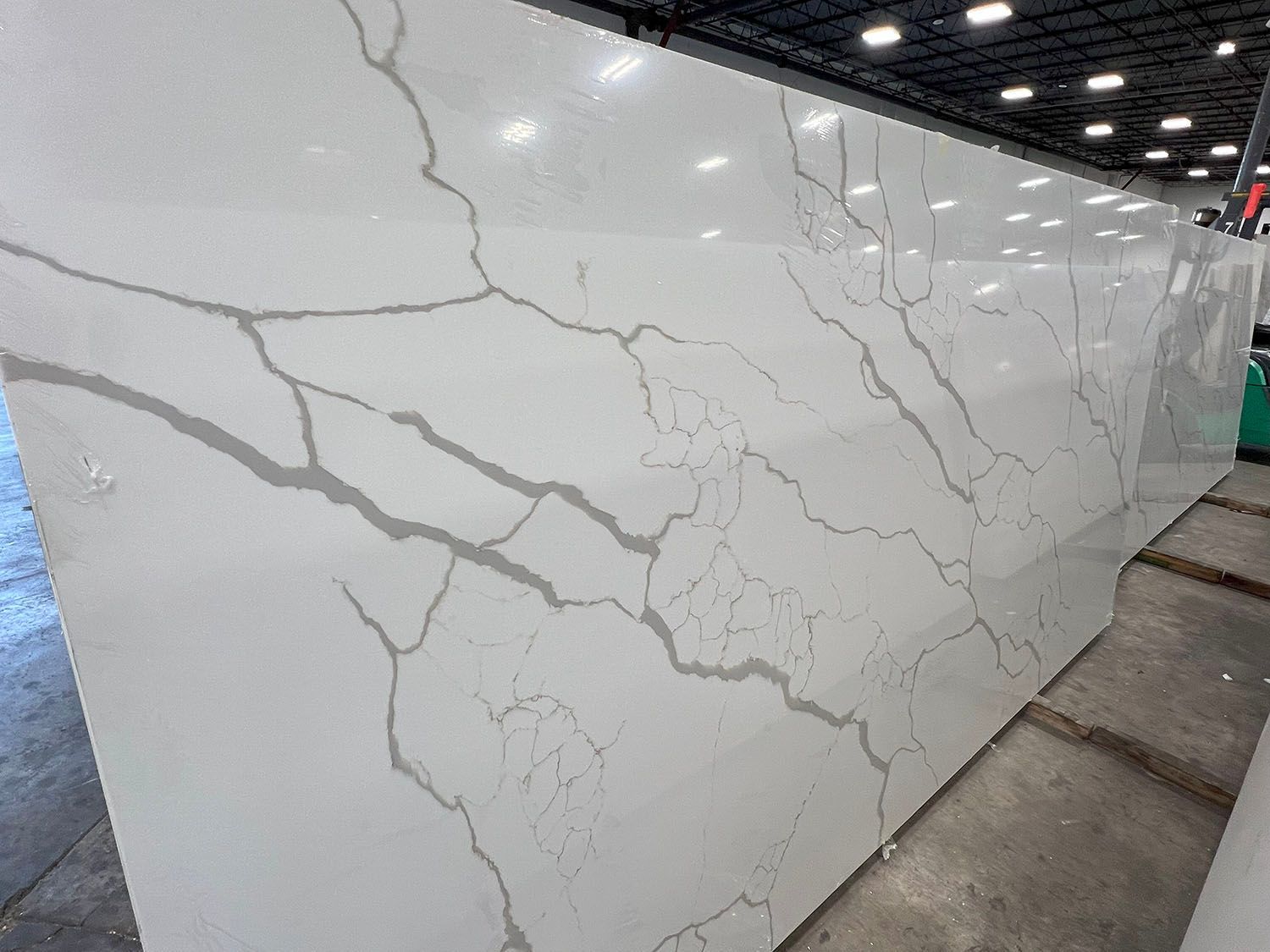 White marble-look wall panel with gray veining in a modern indoor space