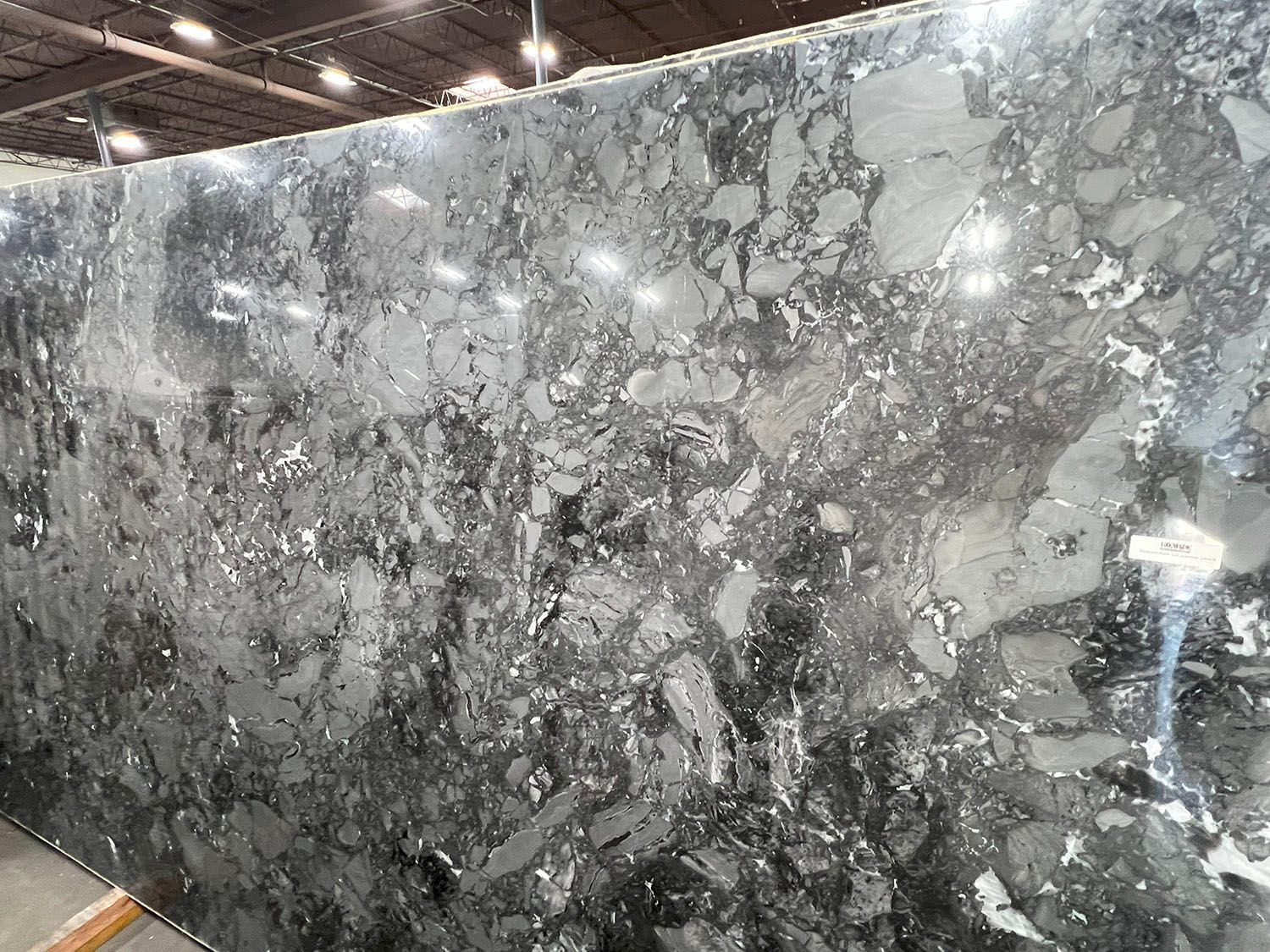 Gray marble slab with white veining displayed in a showroom