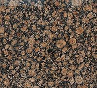 Dark speckled granite surface with tan, brown, and black mottled pattern