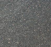 Close-up of rough gray asphalt pavement surface with small reflective specks.