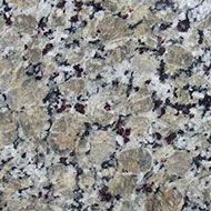 Close-up of speckled beige, gray, black, and pink granite countertop surface