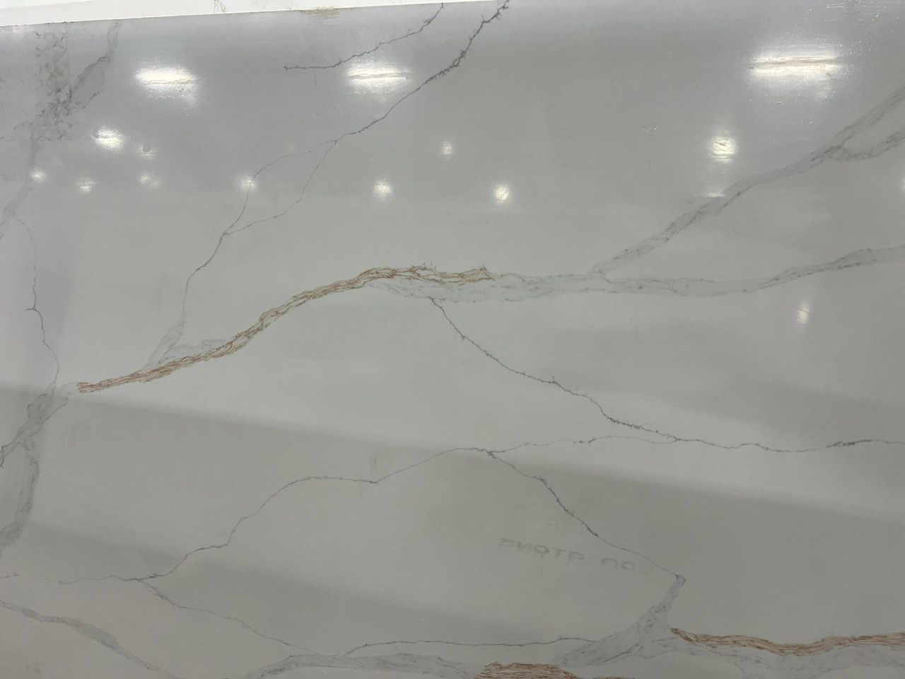 Light gray marble surface with subtle veining and glossy reflections