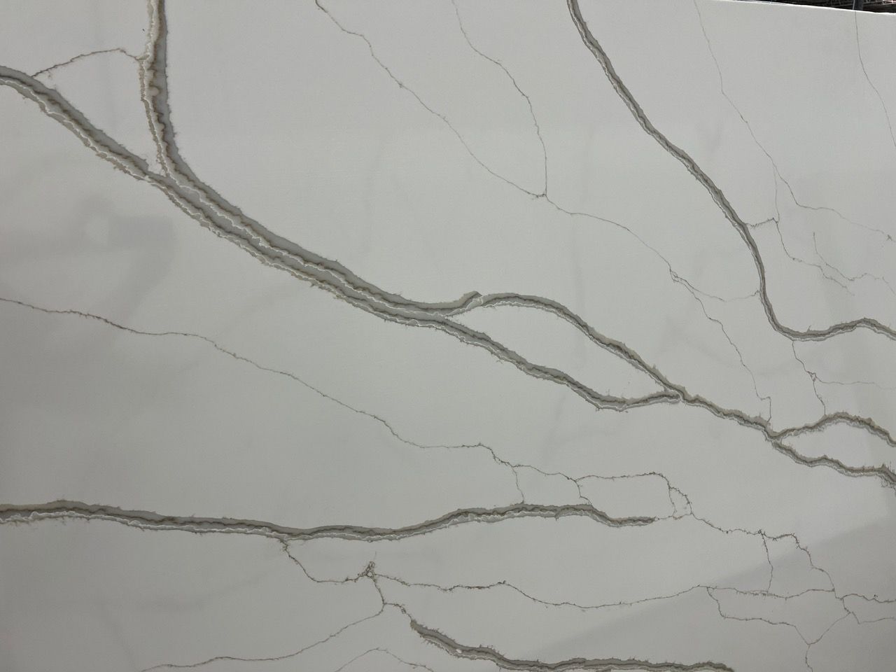 Light gray marble with dark gray veins and cracks across the surface