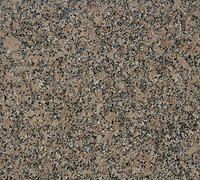 Close-up of a speckled brown, gray, and black stone or granite surface
