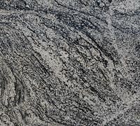 Close-up of gray and black speckled stone with wavy, layered texture