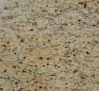 Speckled beige and tan granite surface with black and brown flecks