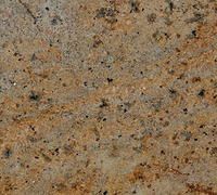 Speckled tan and brown granite surface texture with dark flecks