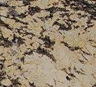 Close-up of a beige and brown speckled stone surface with dark cracks and veins