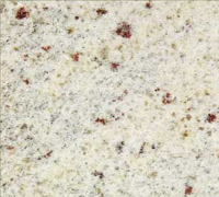 Speckled cream-colored stone surface with small brown and black flecks