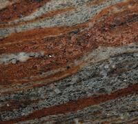 Close-up of red and gray marble with wavy layered texture