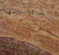 Close-up of layered tan, brown, and reddish rock with wavy mineral bands