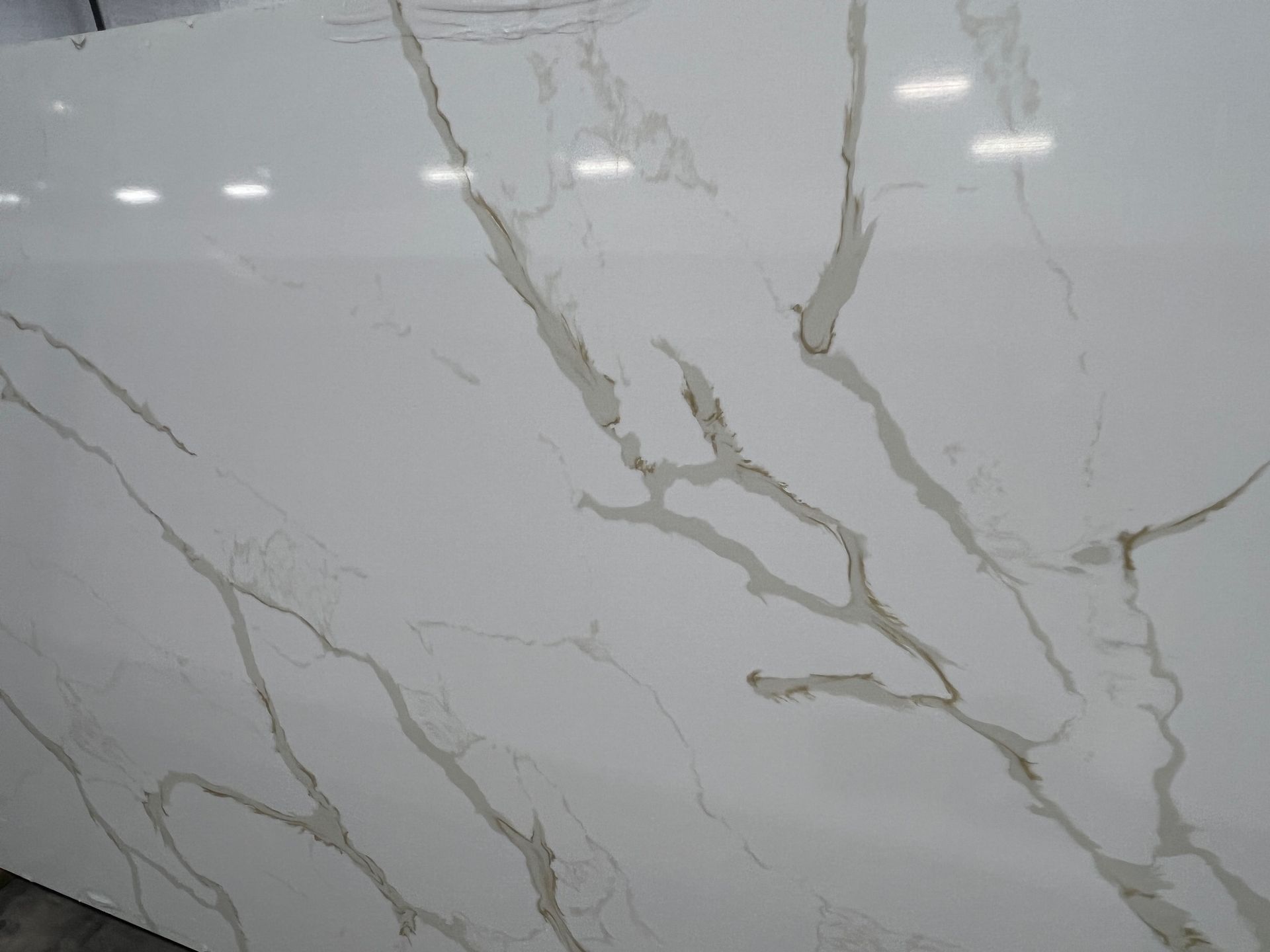 White marble countertop with gray veining and glossy finish