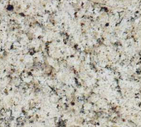 Close-up of a speckled beige granite surface with black, white, and brown flecks