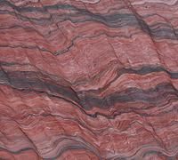 Pink and gray layered rock texture with wavy striations