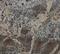 Close-up of a speckled gray, beige, and brown stone surface with rough texture