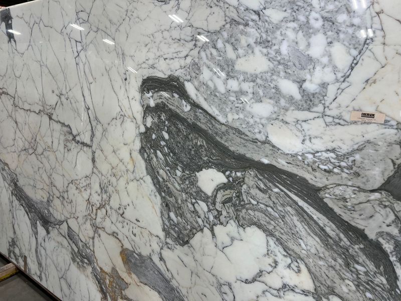 Close-up of white marble with gray veining and a dark diagonal streak