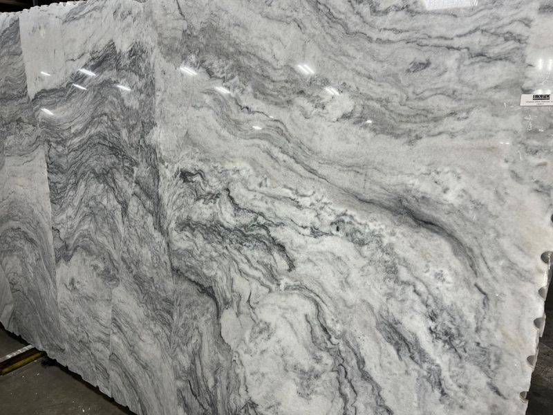 Large gray-and-white marble slab with flowing veined patterns and polished surface