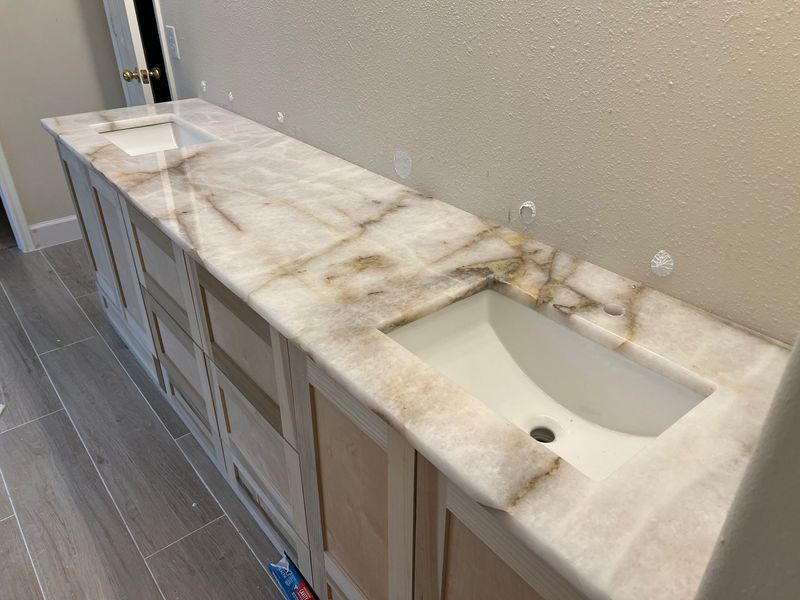 Long marble vanity countertop with built-in sinks in a modern bathroom
