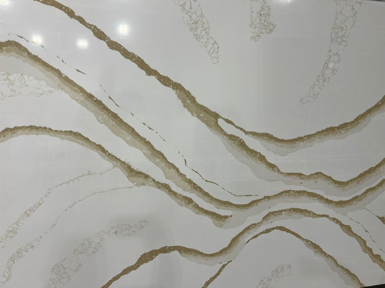 Abstract white marble surface with flowing gold veins and gray streaks
