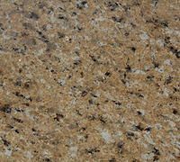 Tan speckled granite surface with black, white, and brown flecks