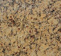 Close-up of a speckled tan, brown, and black stone surface.
