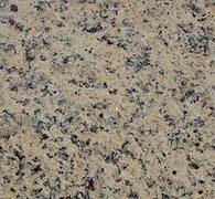 Close-up of beige granite with black, gray, and pink speckles