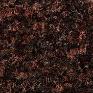 Dark speckled granite surface with brown, black, and reddish tones