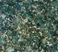 Close-up of a green and gray speckled stone or granite surface