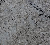 Close-up of rough gray stone surface with dark speckles and cracks