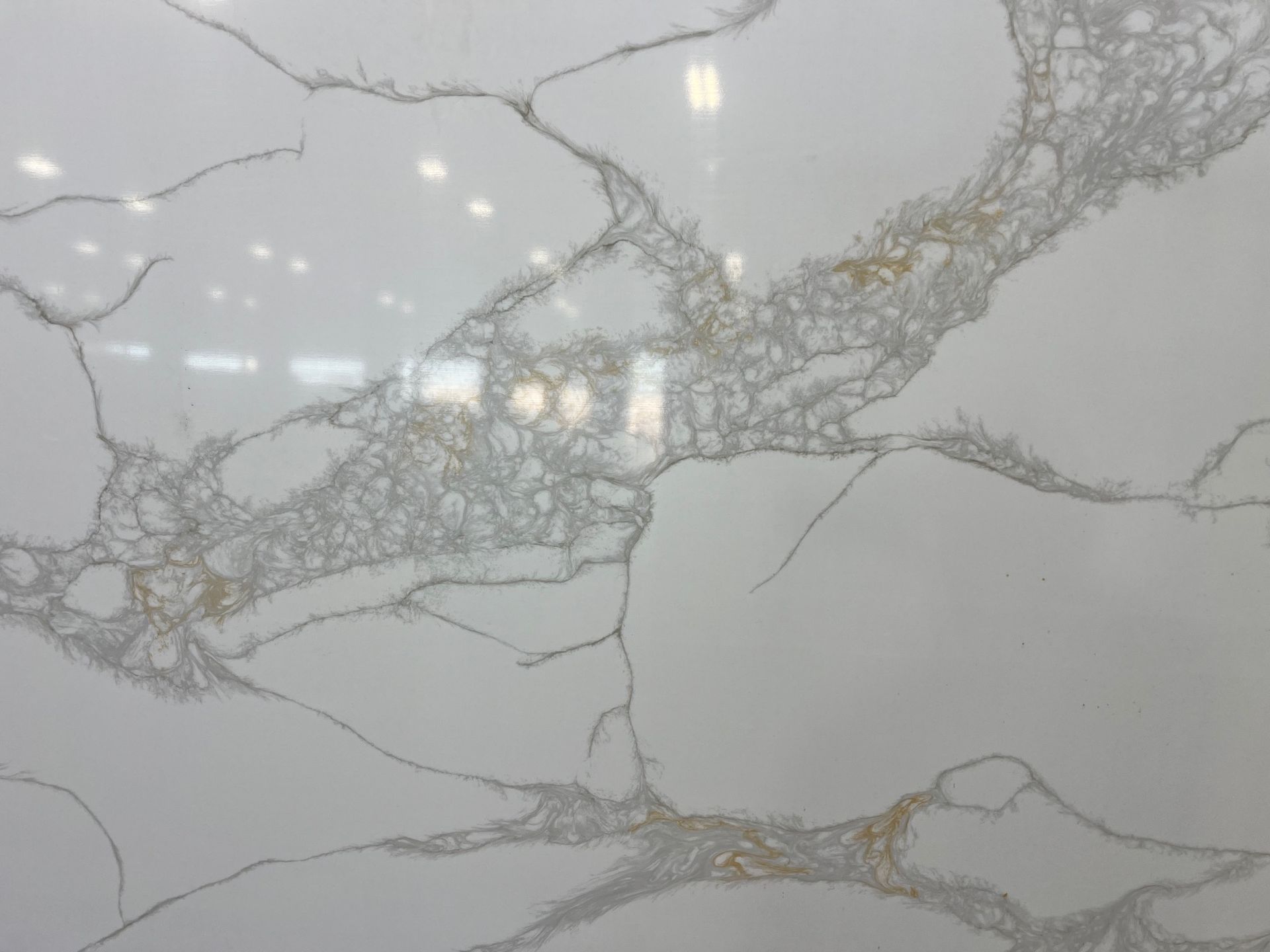 Gray marble surface with white veining and subtle gold accents