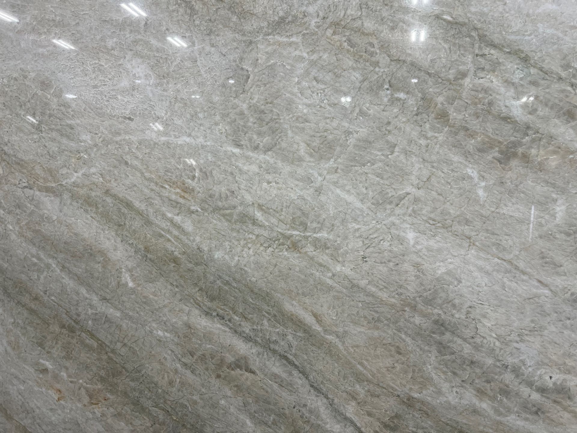 Gray stone surface with subtle white streaks and a textured, marbled pattern