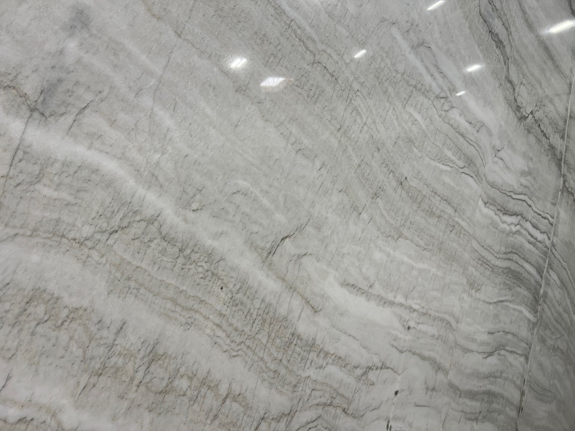 Gray marble surface with subtle white veining and polished reflections