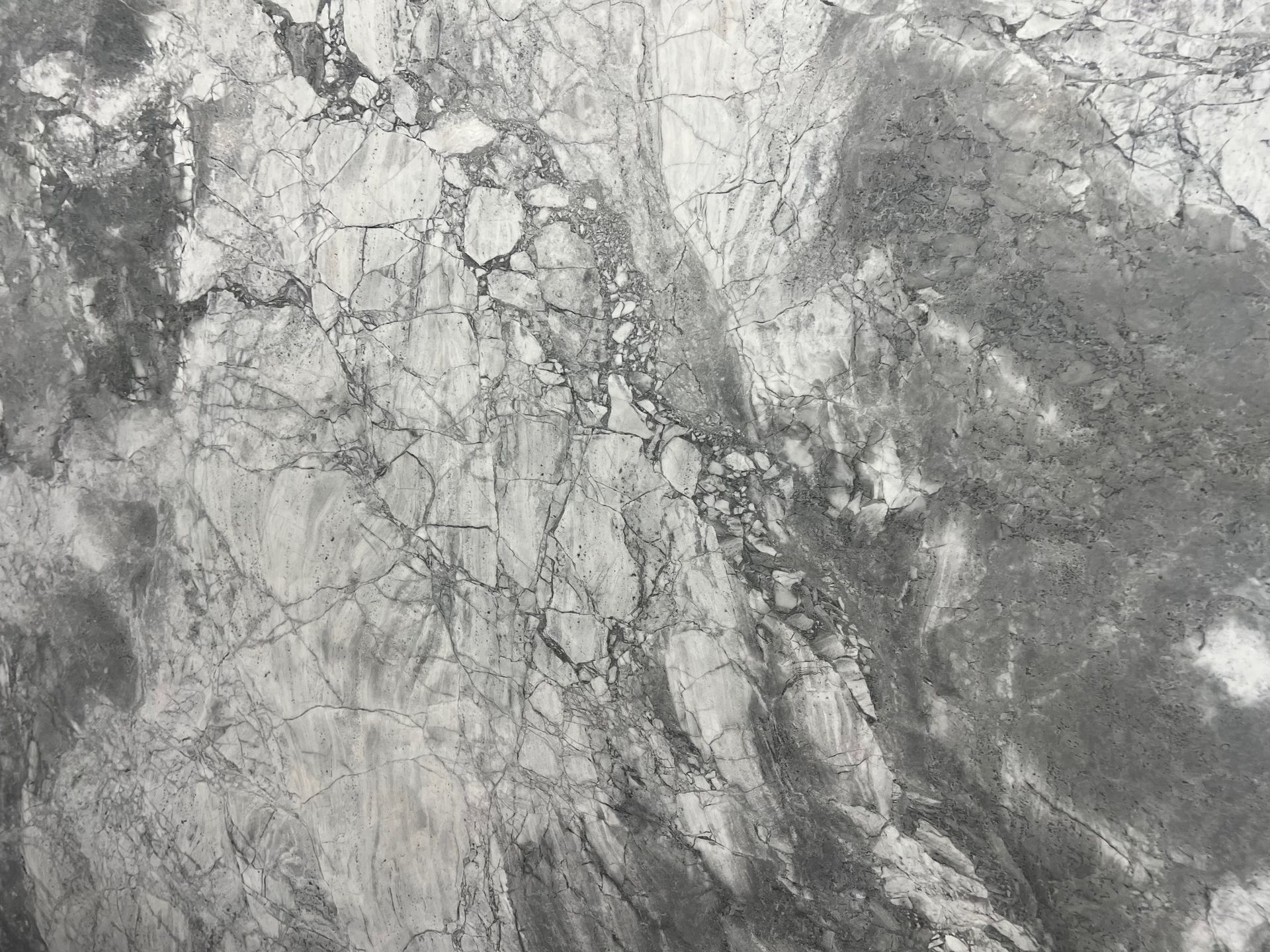 Gray and white marbled stone texture with veined, cloudy patterns